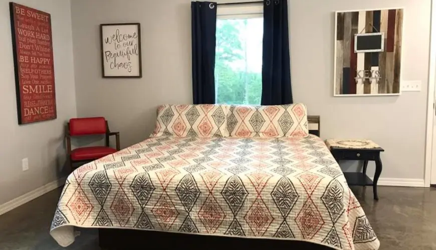 A bed with a large quilt on it