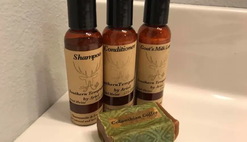 Three bottles of shampoo and a bar of soap.