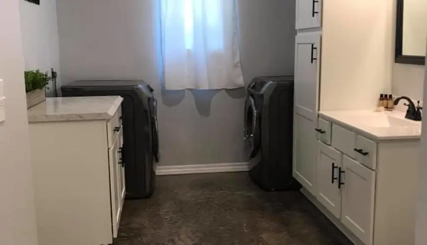 A kitchen with two suitcases on the floor