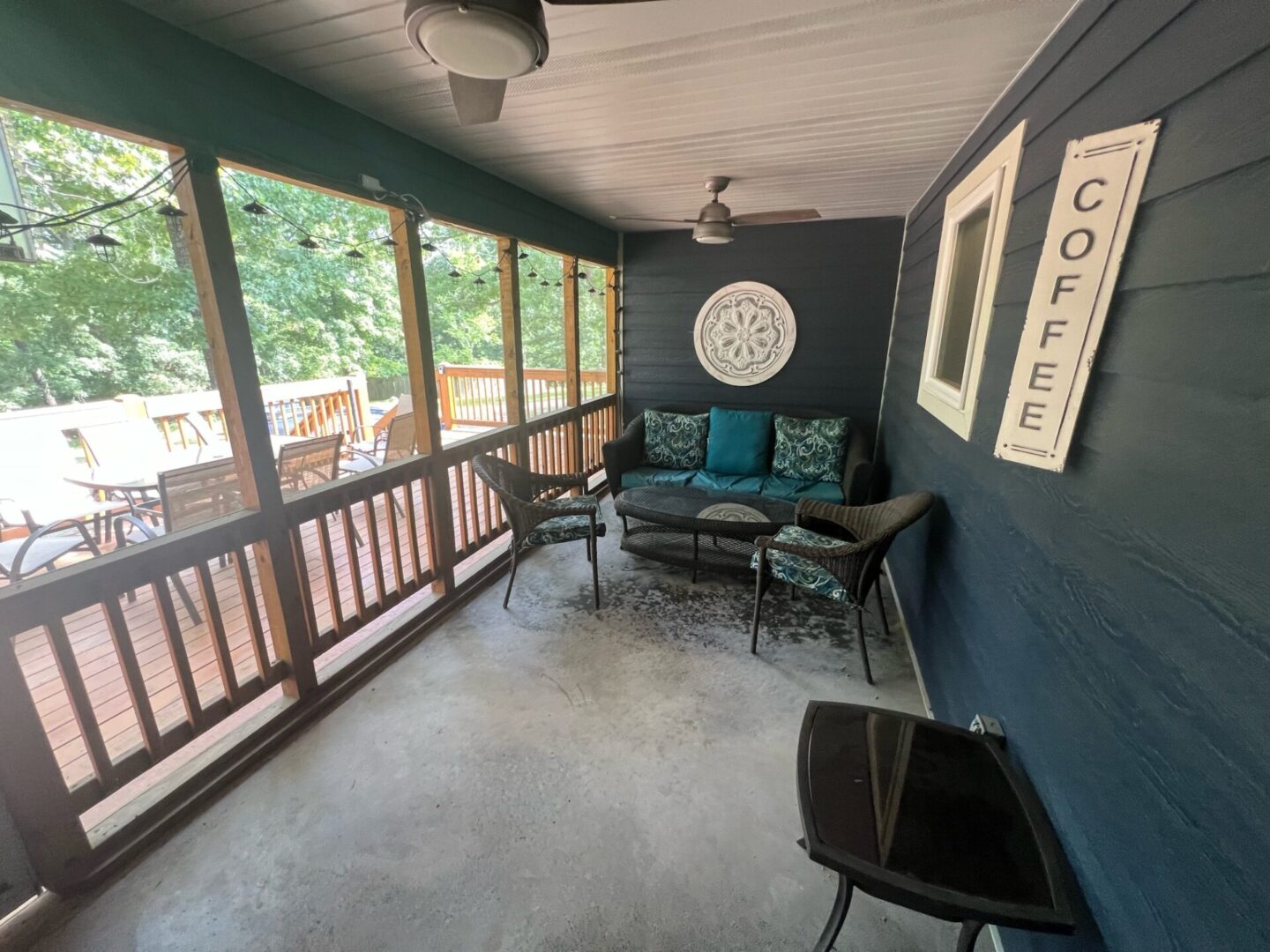 A porch with a couch and chairs in it