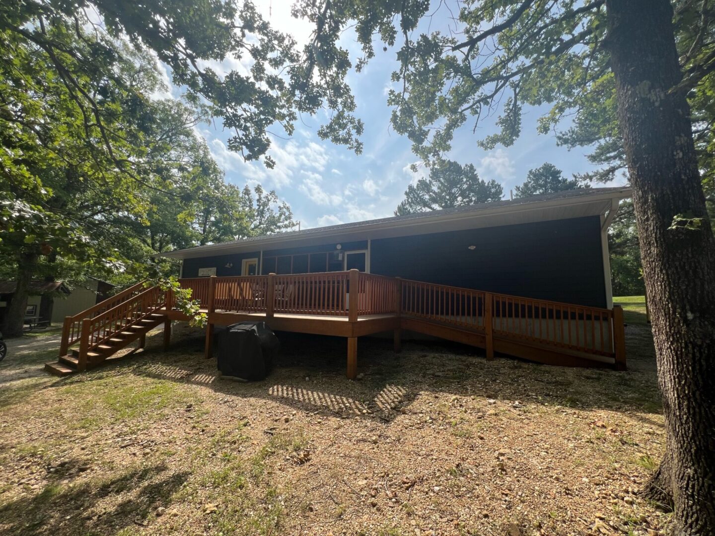 A large wooden deck in the middle of a field.